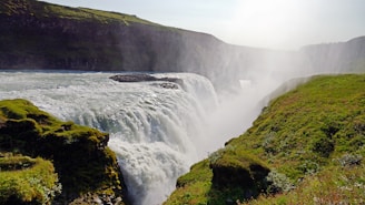 a large waterfall with water cascading down the side of it