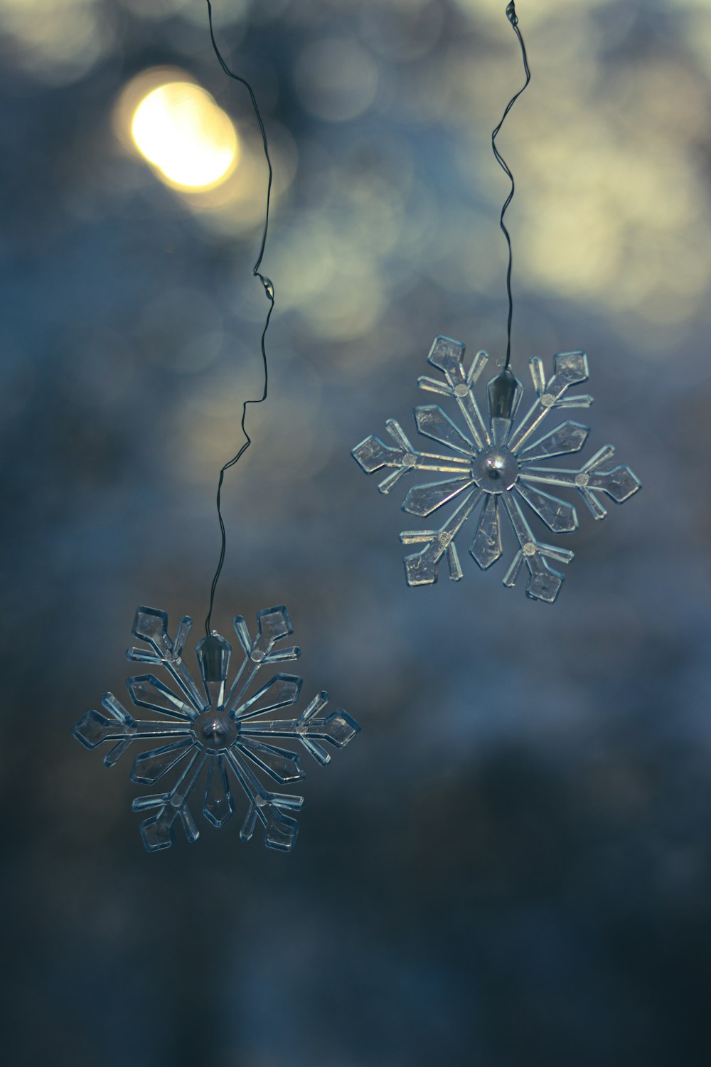 a couple of snowflakes hanging from a string