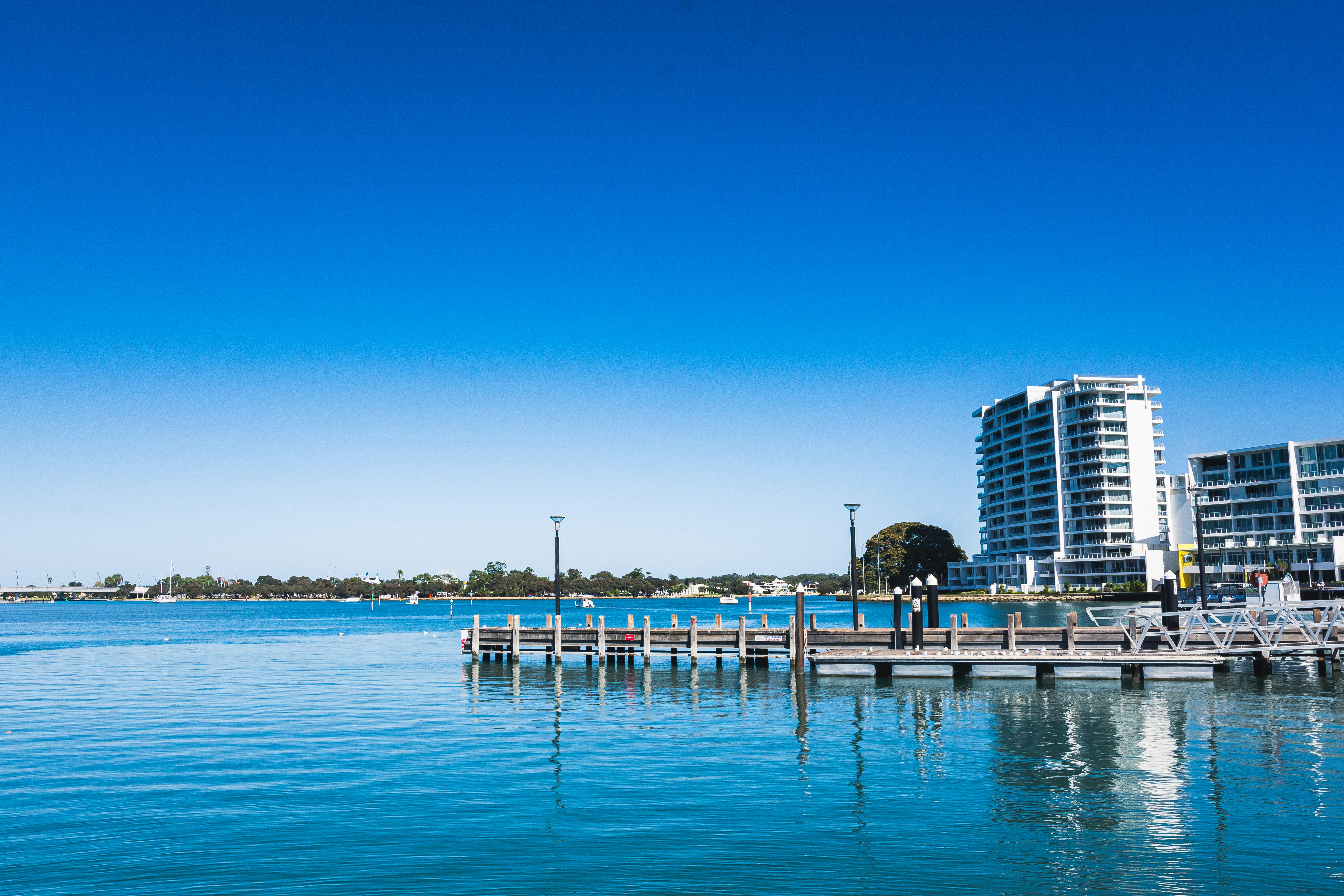 a body of water with buildings in the background