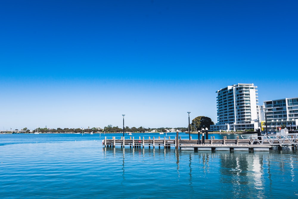 a body of water with buildings in the background