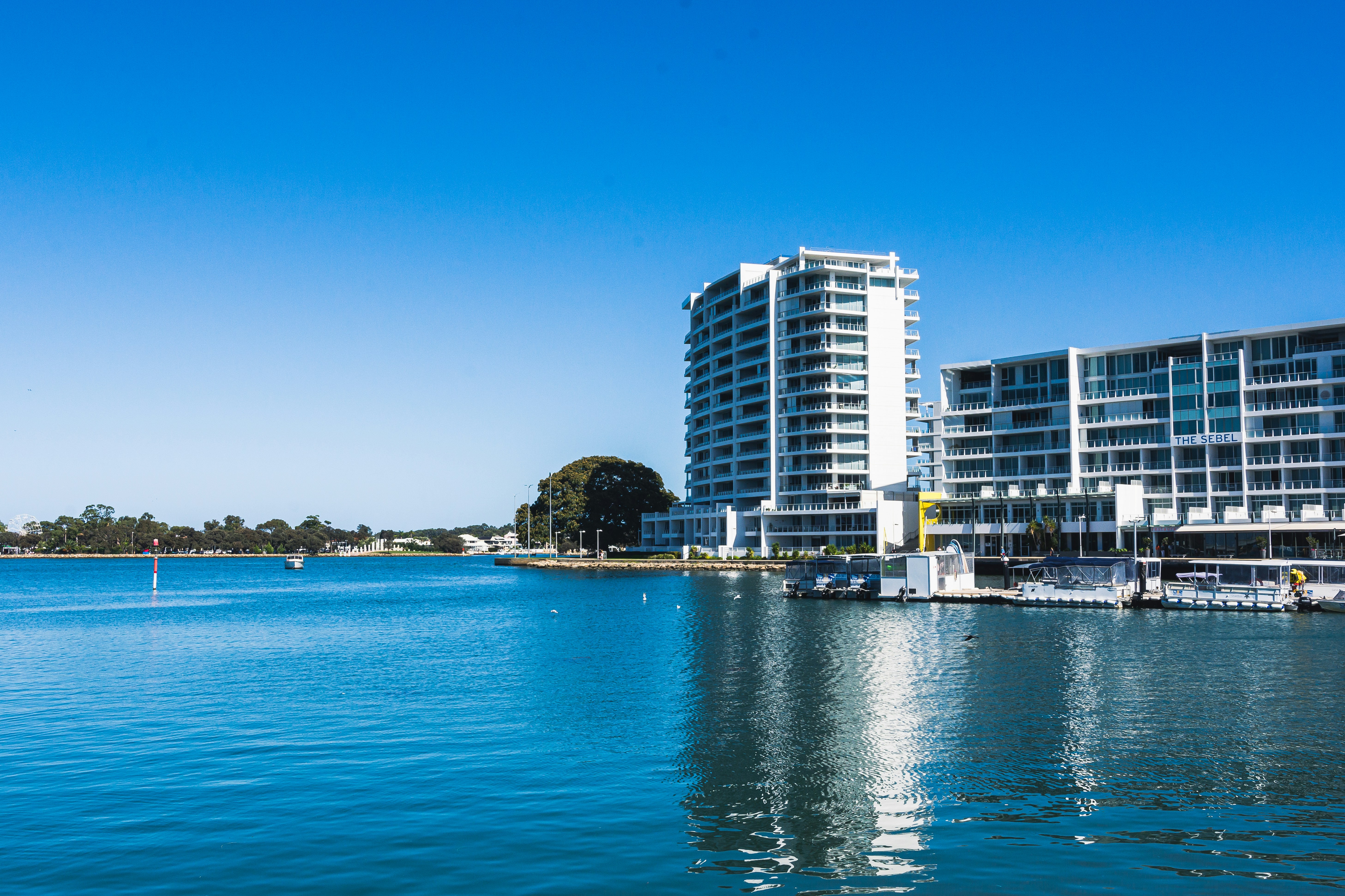 a body of water with a building in the background