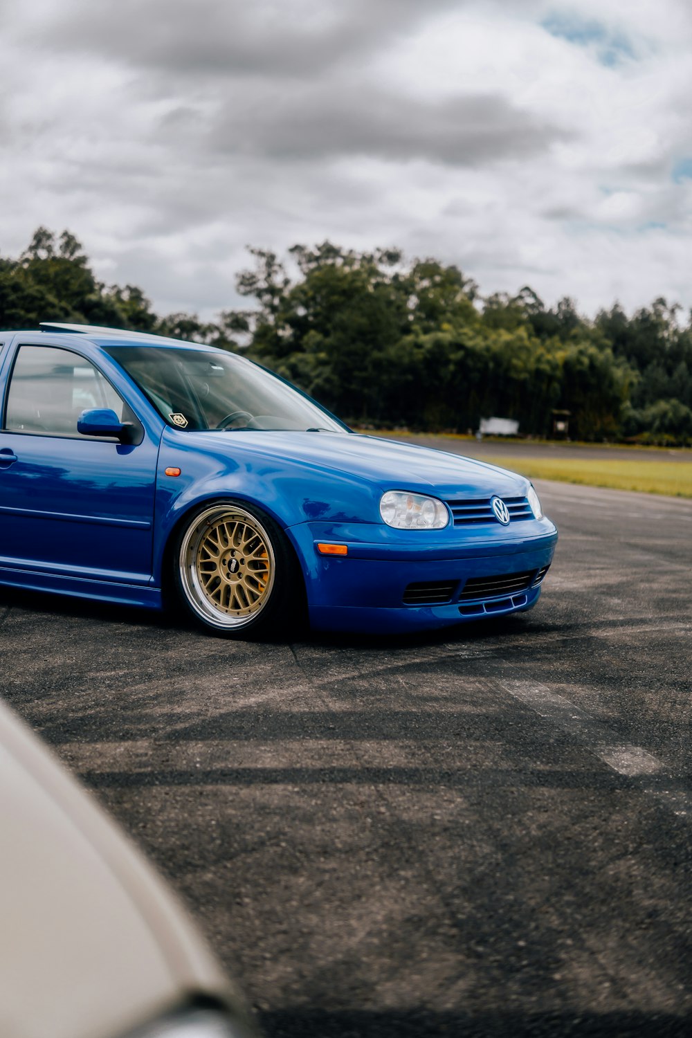 a blue car parked in a parking lot