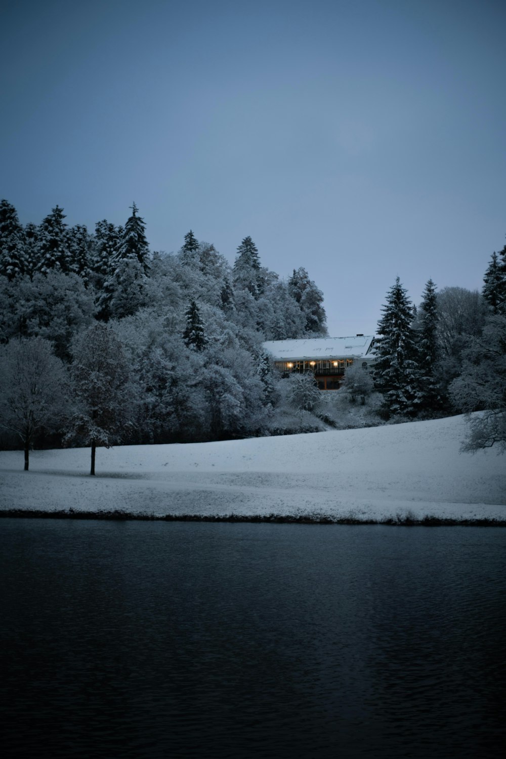 a house on a hill covered in snow