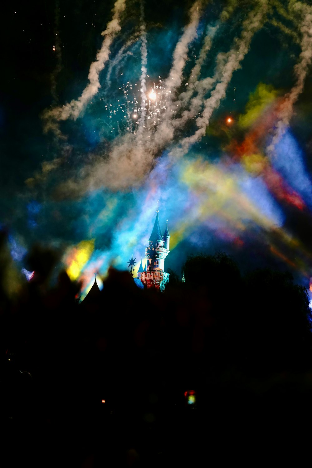 a castle is lit up with colorful lights