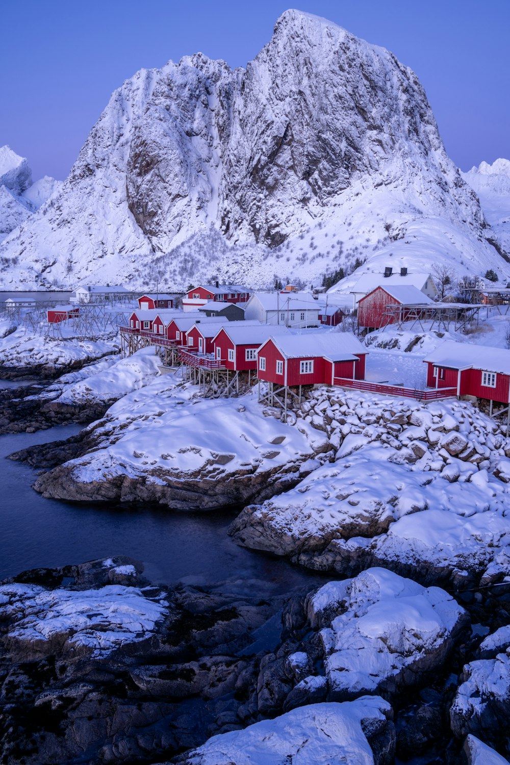 a snowy landscape with a mountain in the background