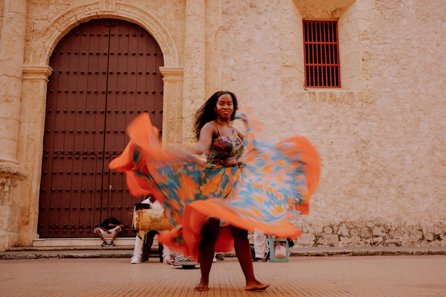 A woman dancing a traditional Colombian dance in front of a building in Cartagena