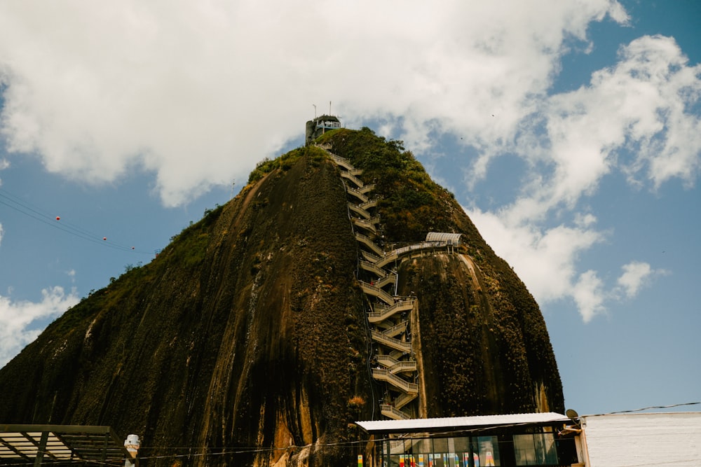 a very tall mountain with a ladder going up it's side