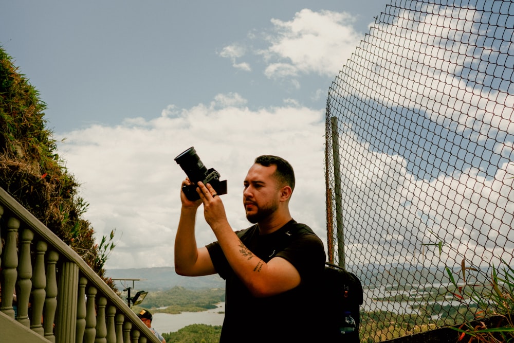 a man holding a camera up to take a picture