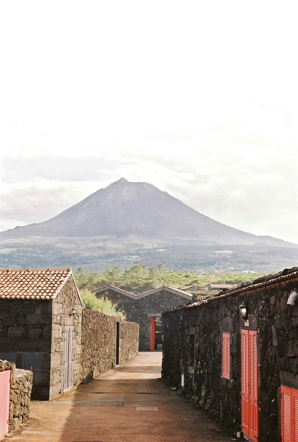 a stone building with a mountain in the background