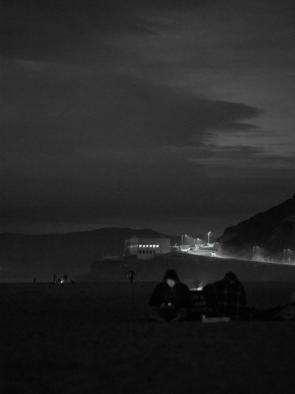 a couple of people sitting on top of a beach