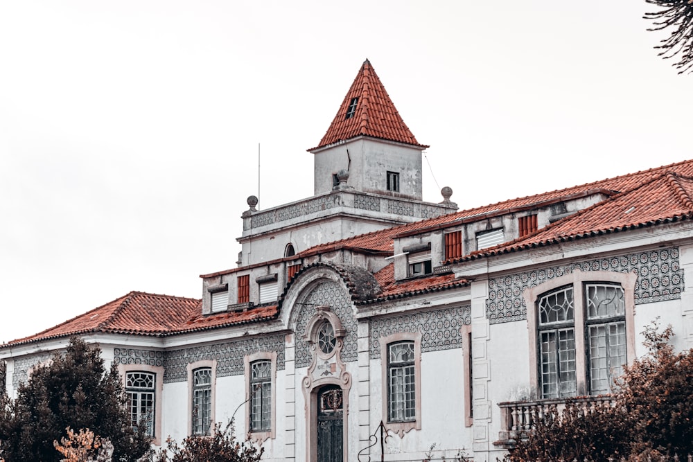 a large white building with a red roof