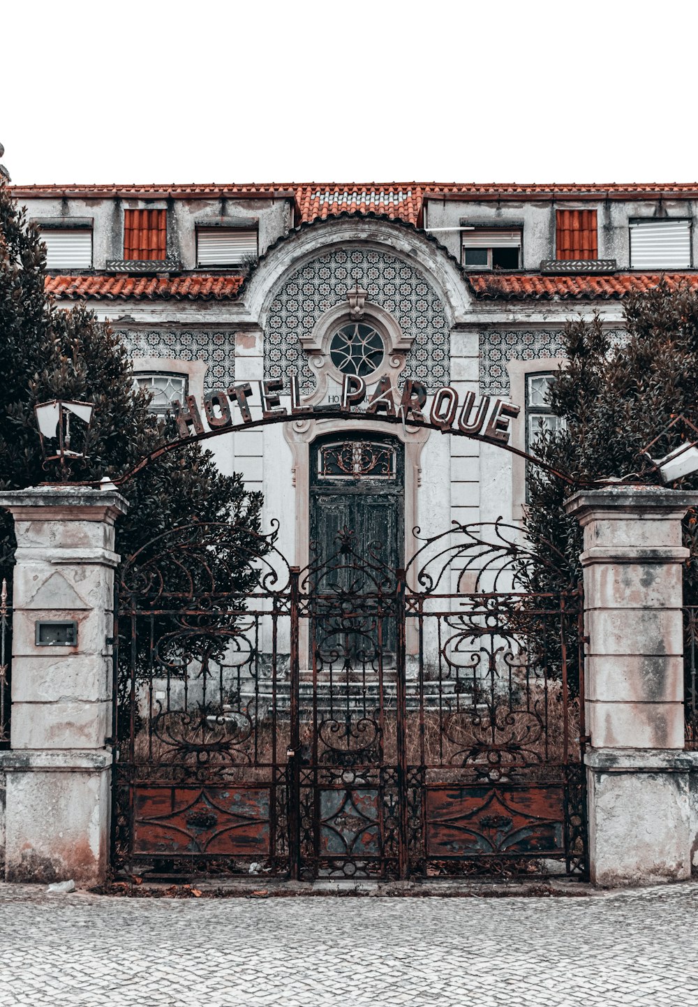 an old building with a gate and a clock on it