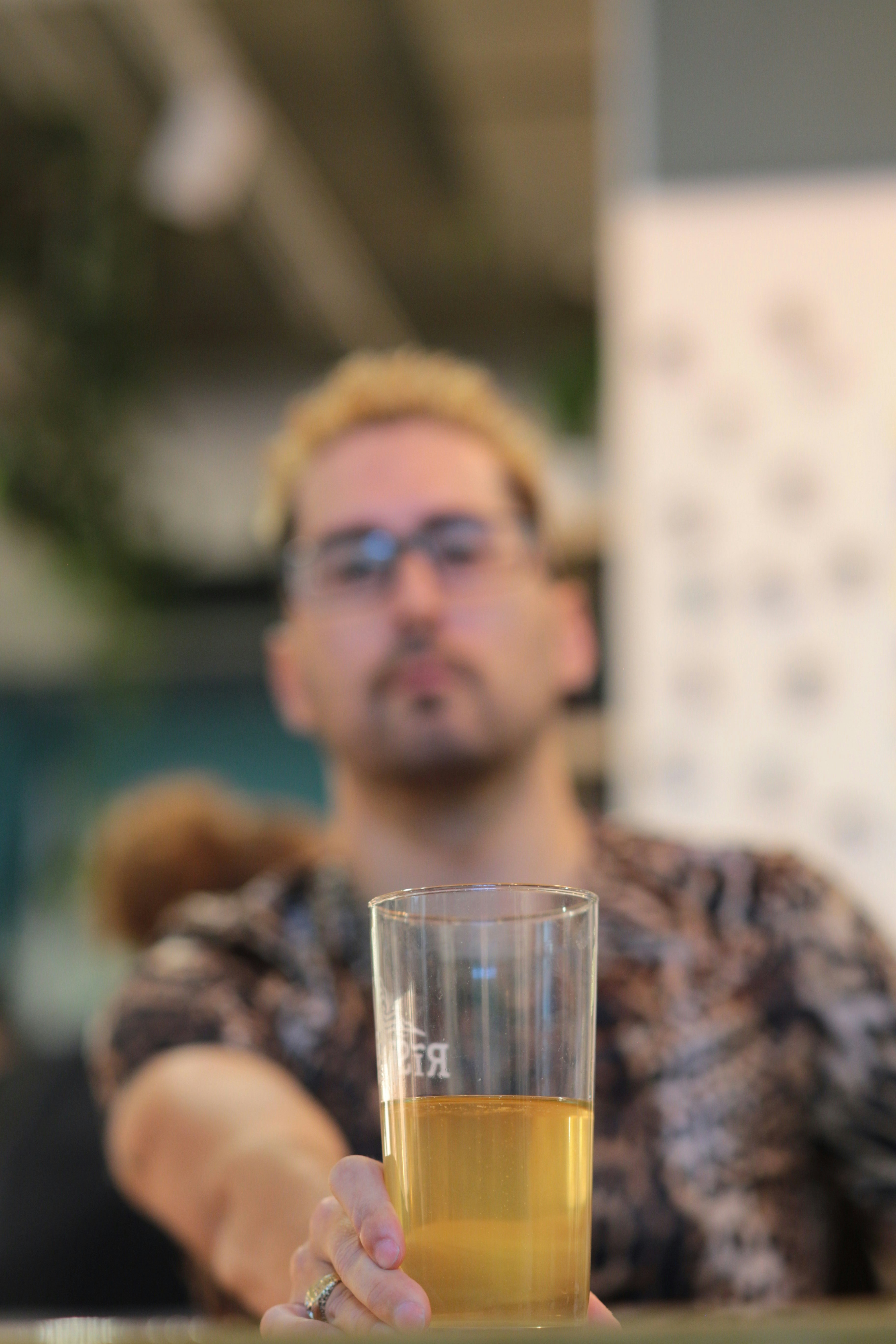 a man sitting at a table with a glass of beer