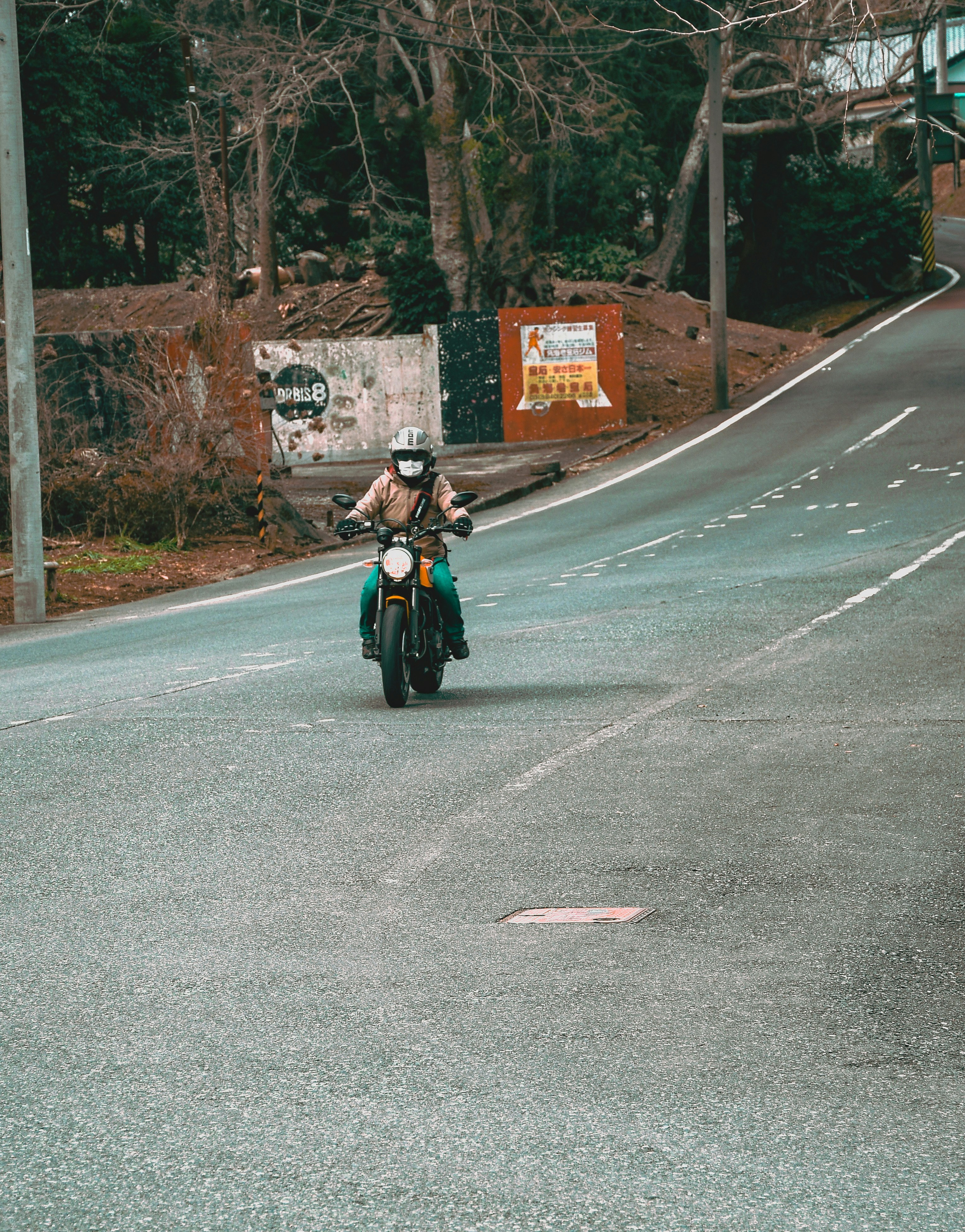 a person riding a motorcycle down a street
