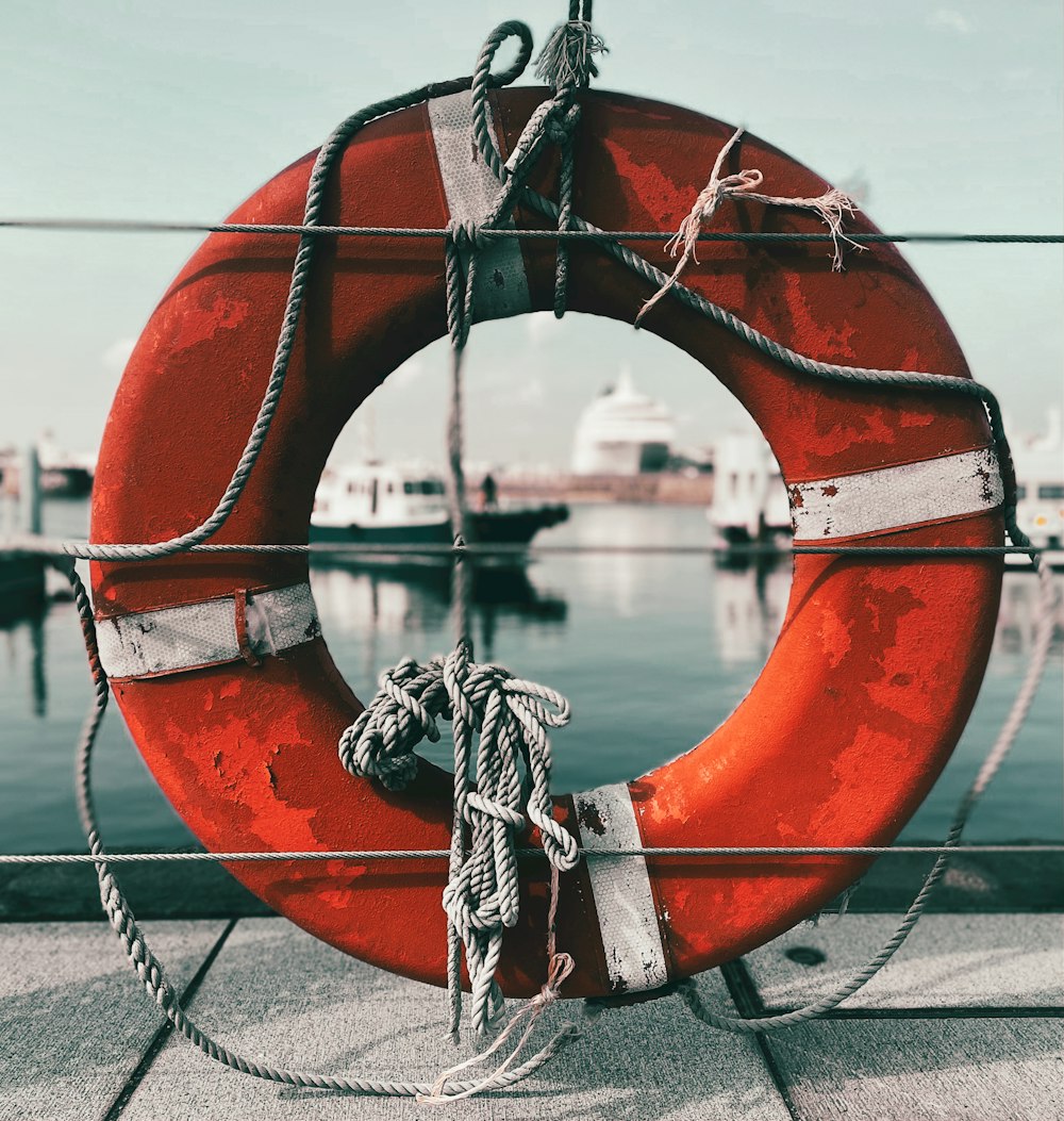 a life preserver on a dock with a boat in the background