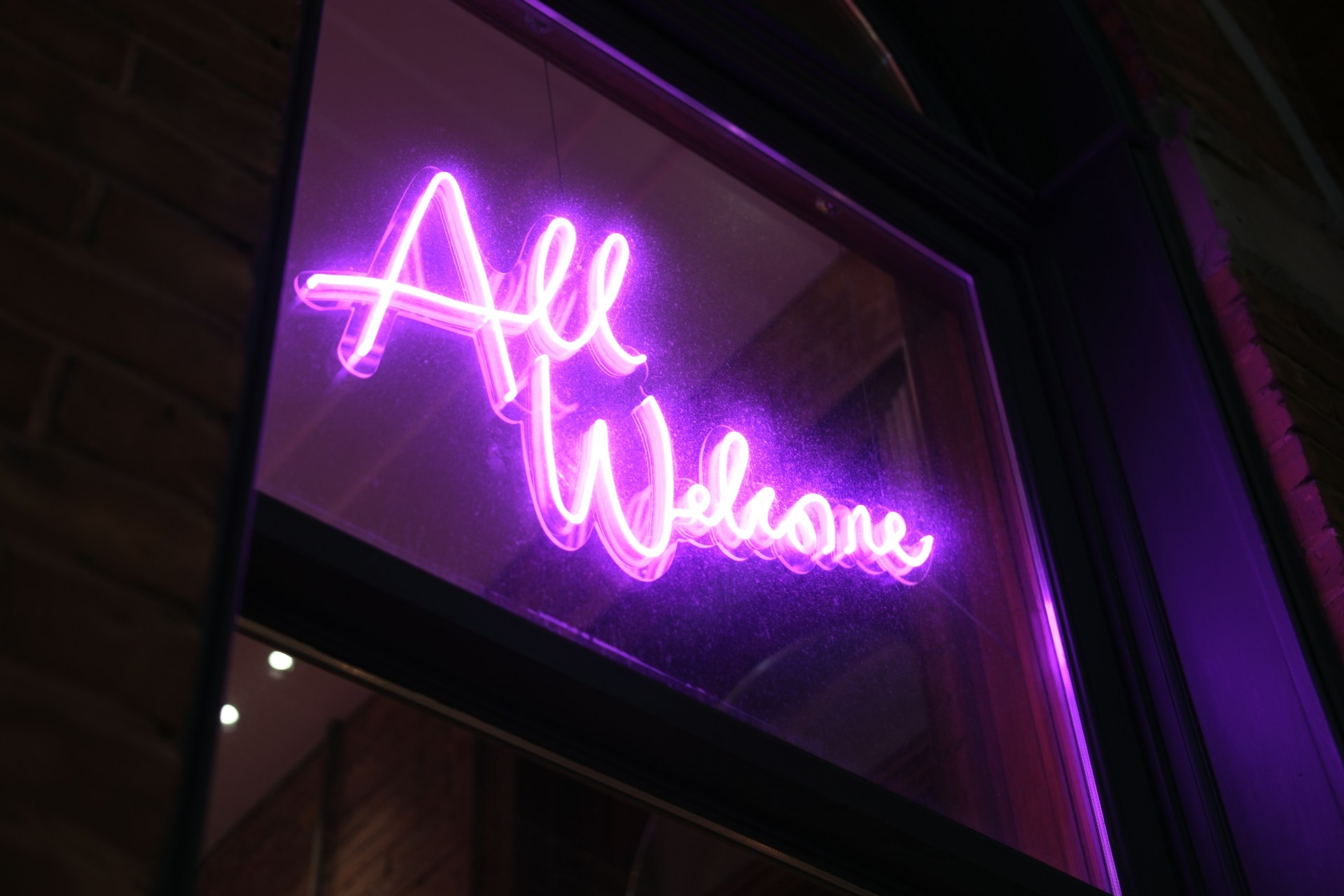 a purple neon sign that says all we know