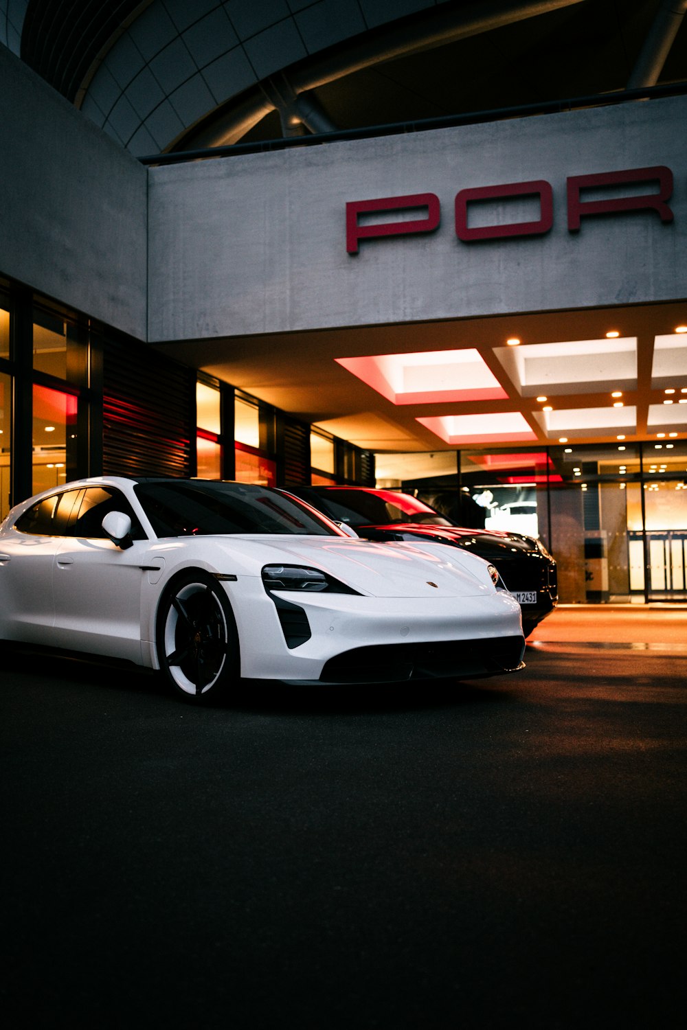 a white sports car parked in front of a building