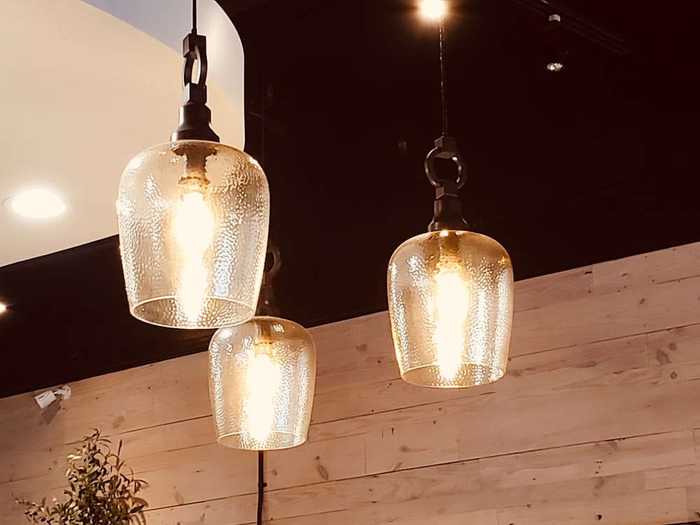 three lights hanging from a ceiling in a restaurant