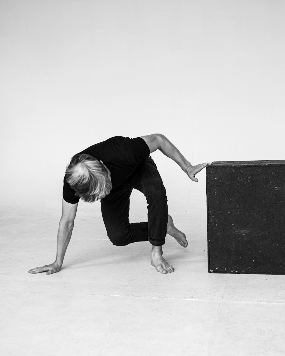 a man is doing a handstand in front of a suitcase