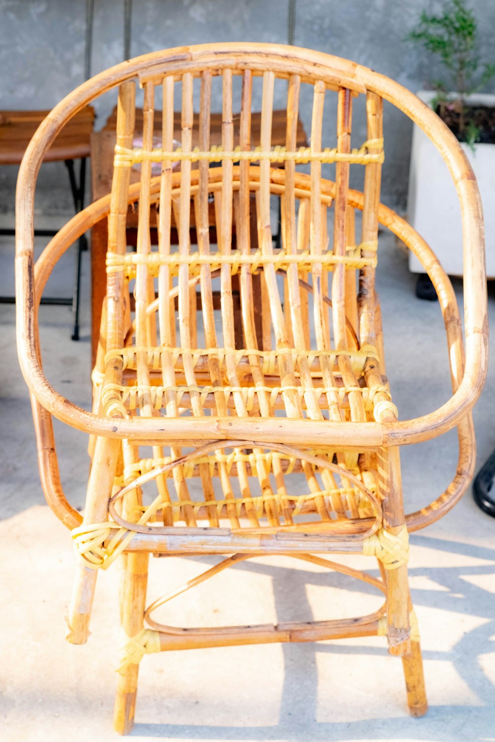 a wicker chair sitting on top of a cement floor