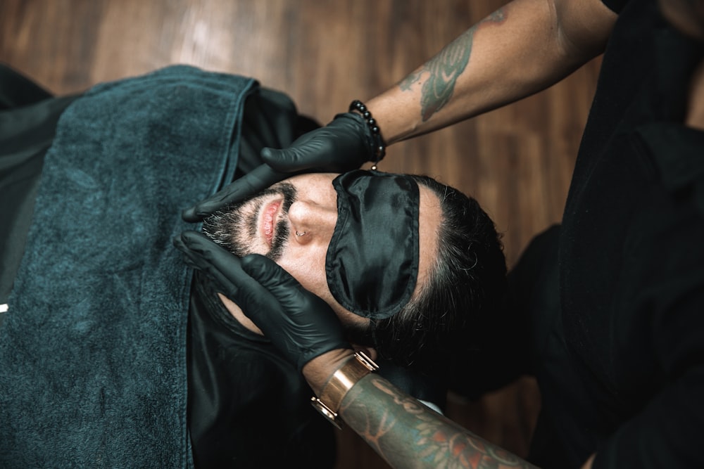 a man getting his hair cut by a barber