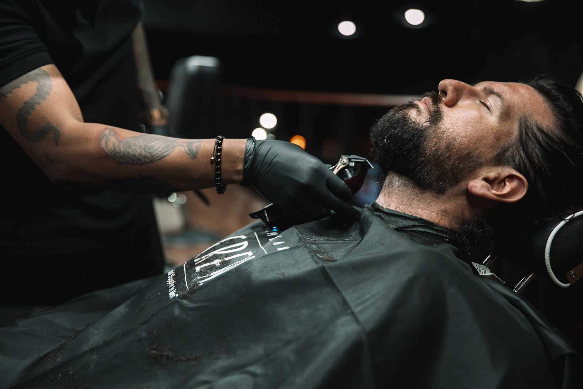 a man getting his hair cut at a barber shop
