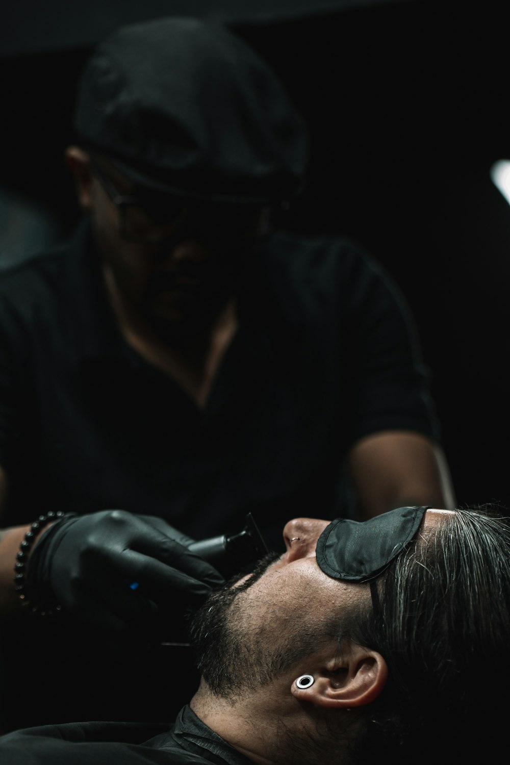 a man getting his hair cut by a barber