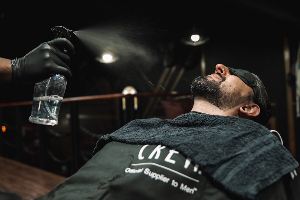 a man getting a haircut at a barber shop