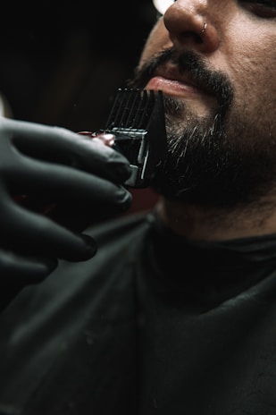 a man getting his hair cut by a barber