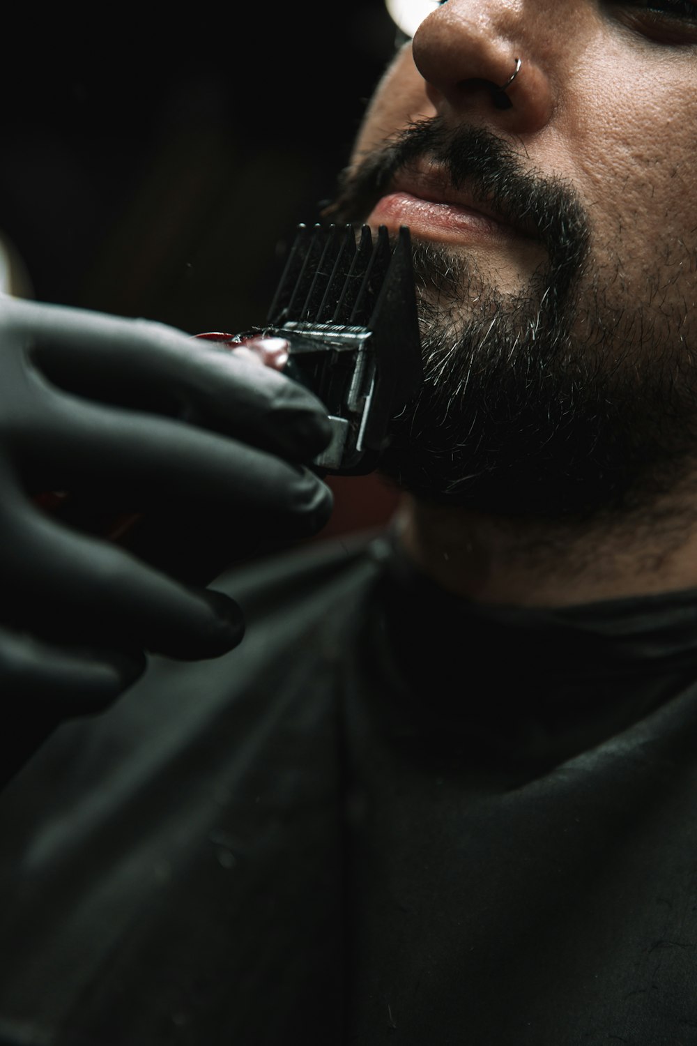 a man getting his hair cut by a barber