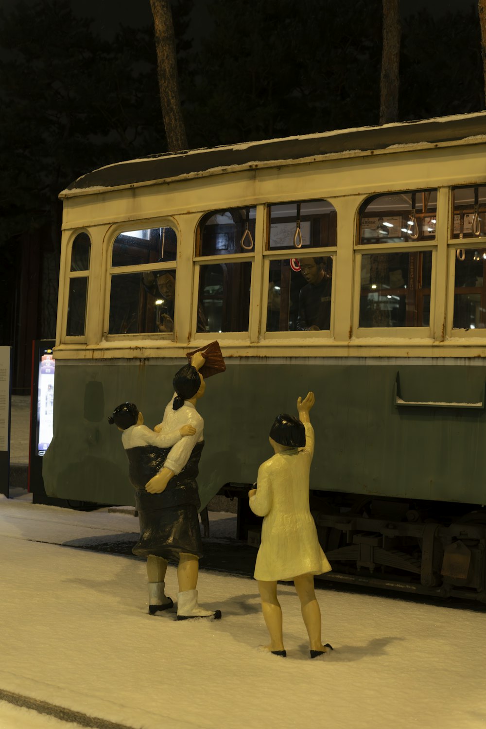 a couple of people that are standing in front of a train