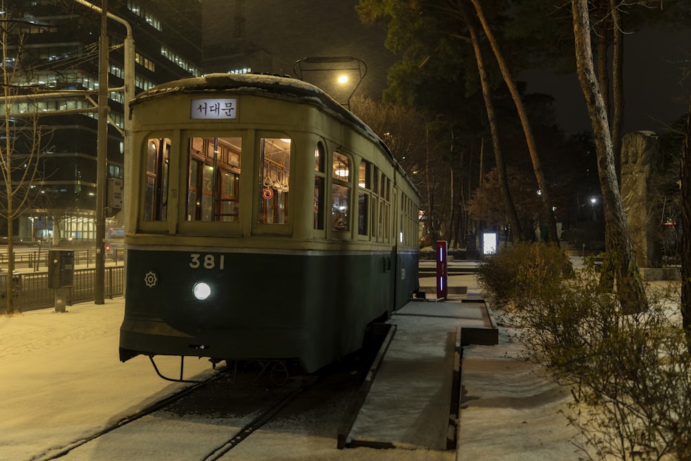 a trolley car on a snowy night in a city