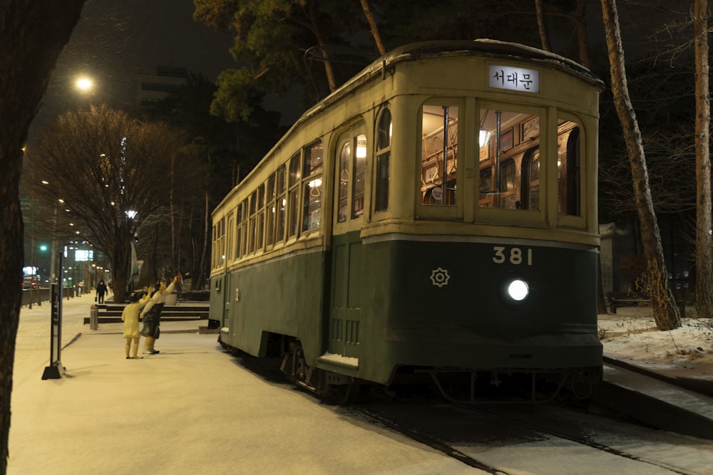 a trolley car on the tracks at night