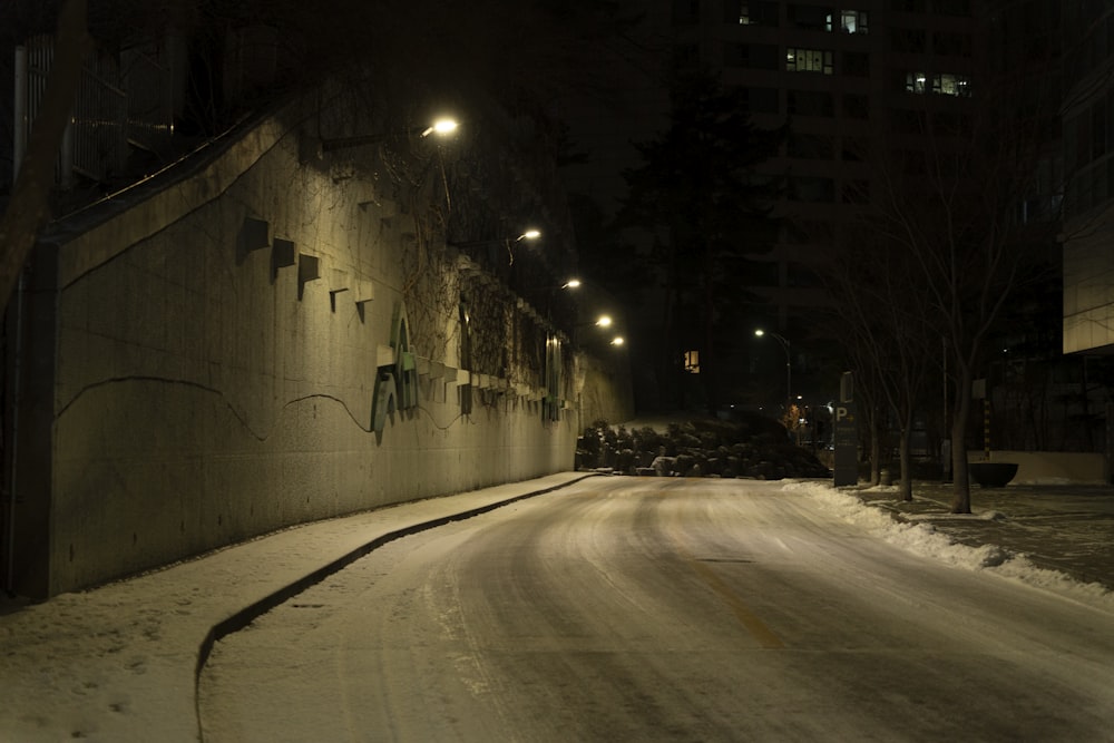 a city street at night covered in snow