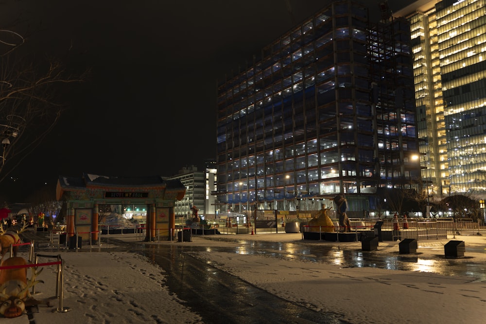 a city street at night with snow on the ground