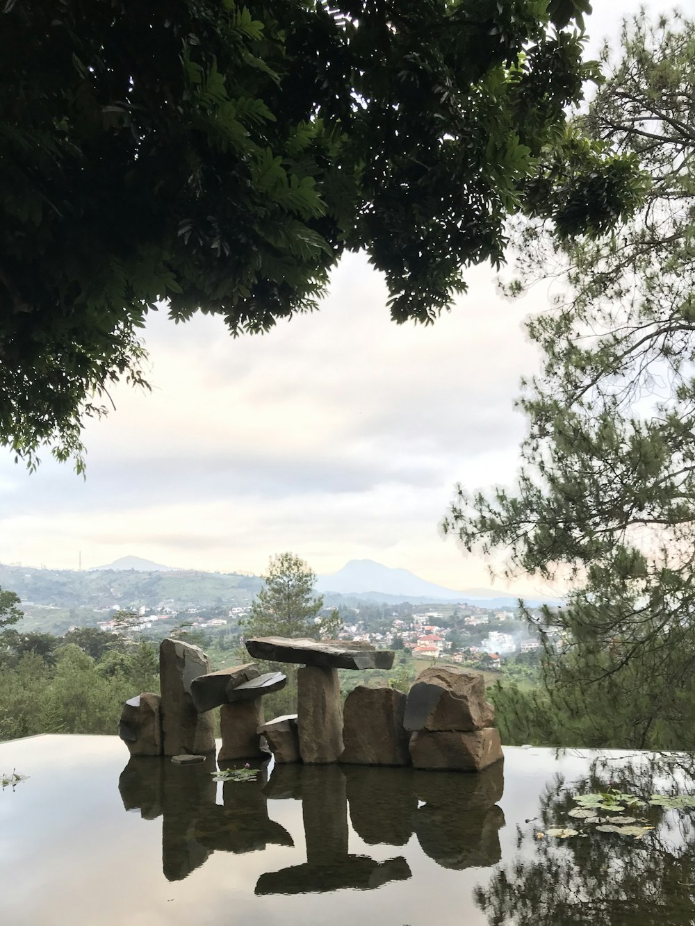 a large rock sitting in the middle of a pool