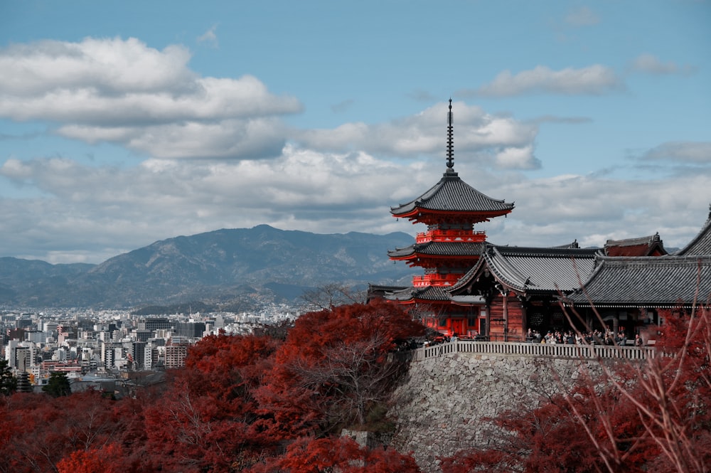 a tall building with a red tower on top of it