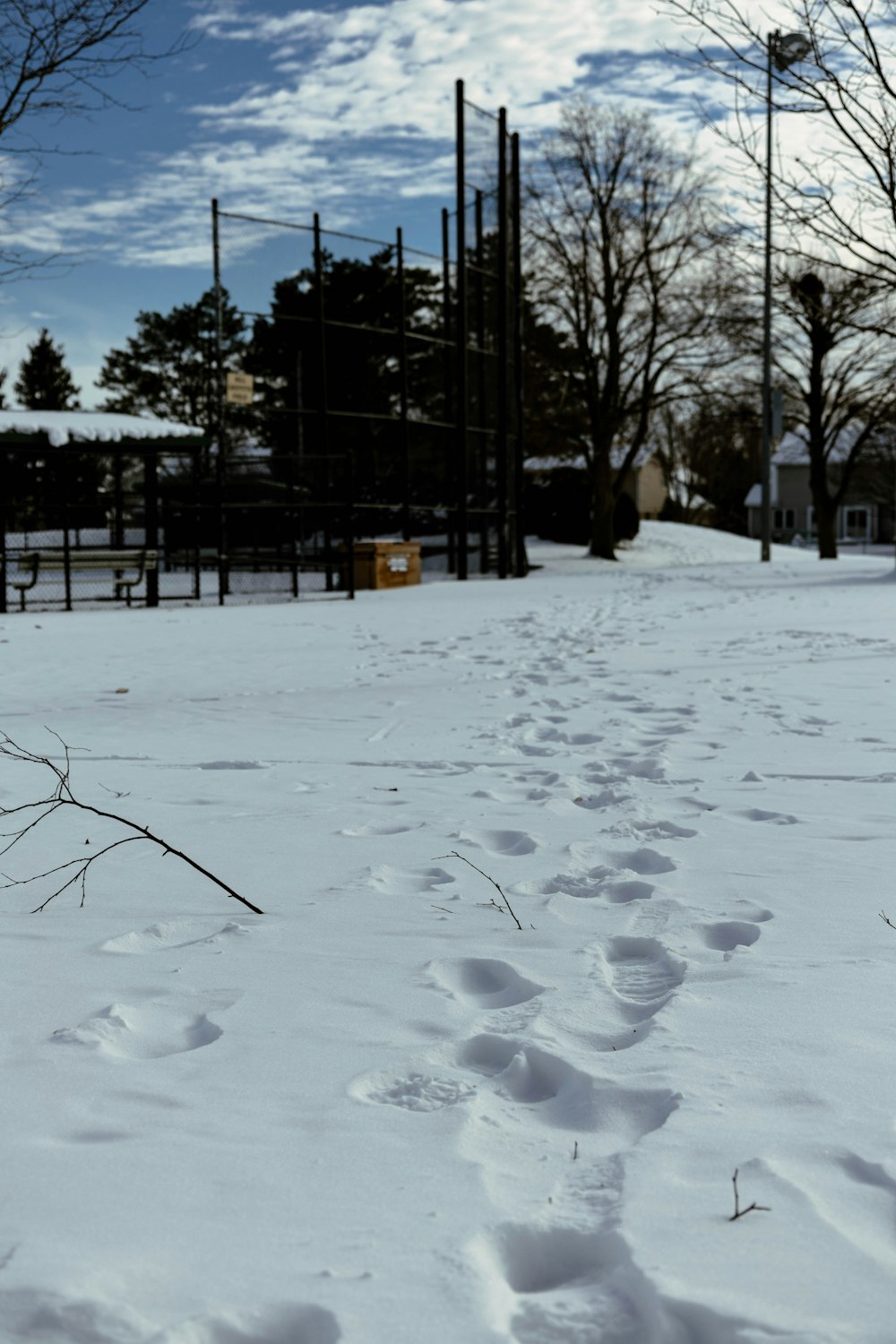 a snow covered field with a fire hydrant in the distance