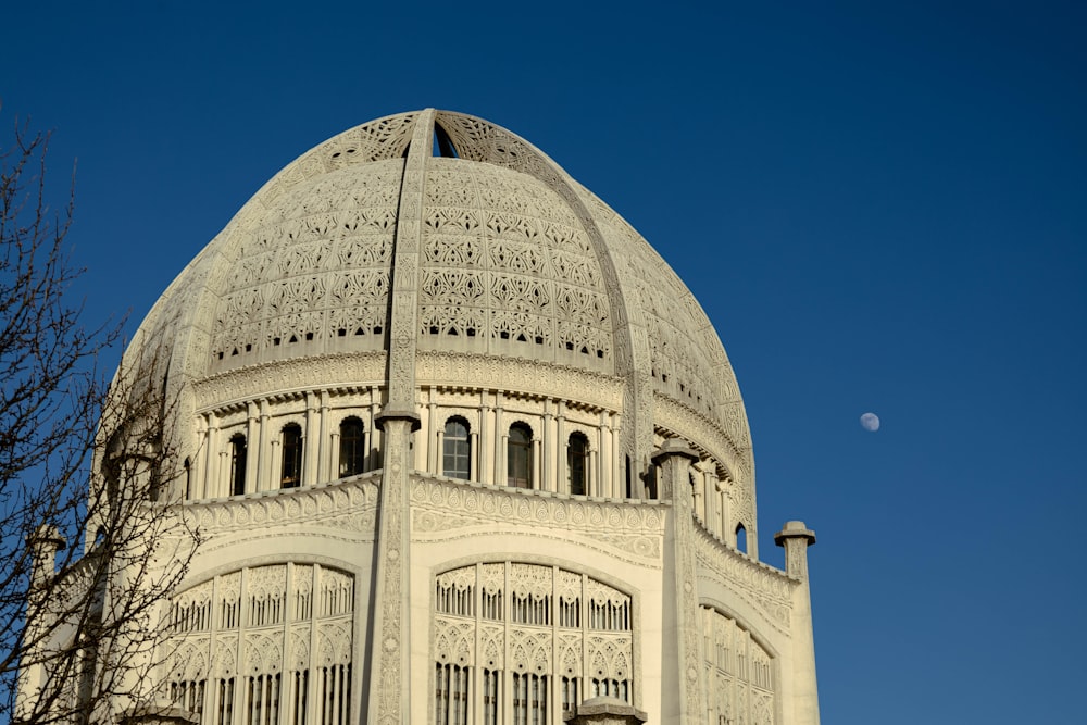 a large white building with a clock on it's face