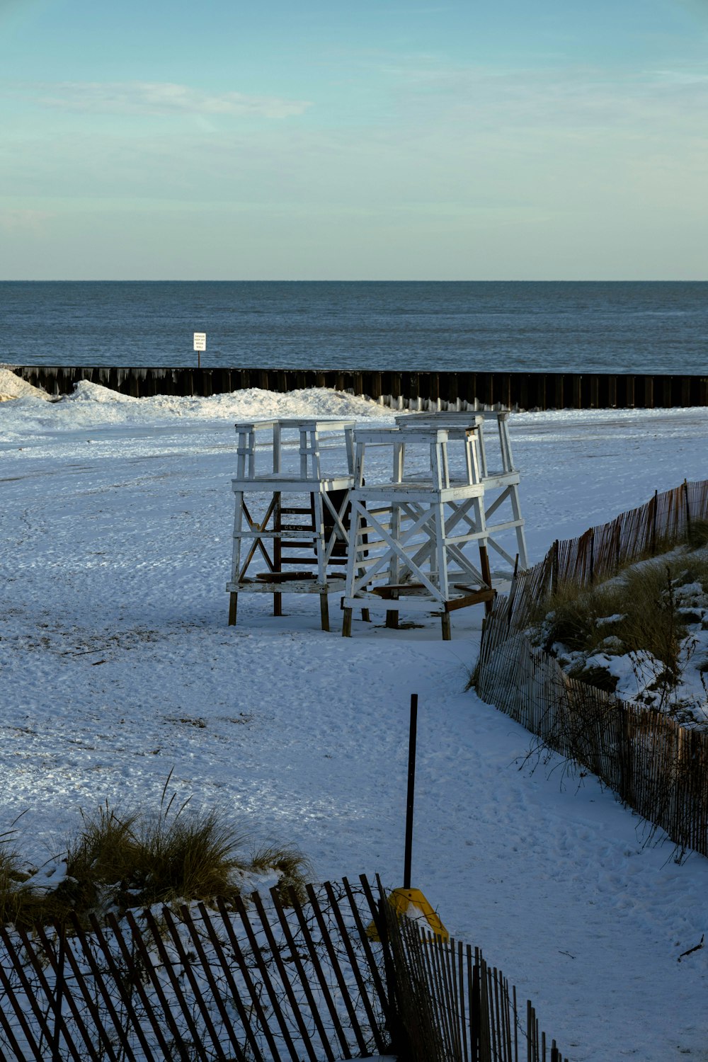 a lifeguard tower on a beach next to the ocean