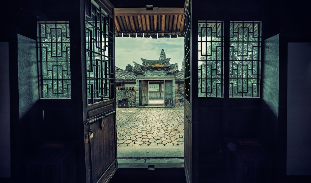 an open door leading to a stone courtyard