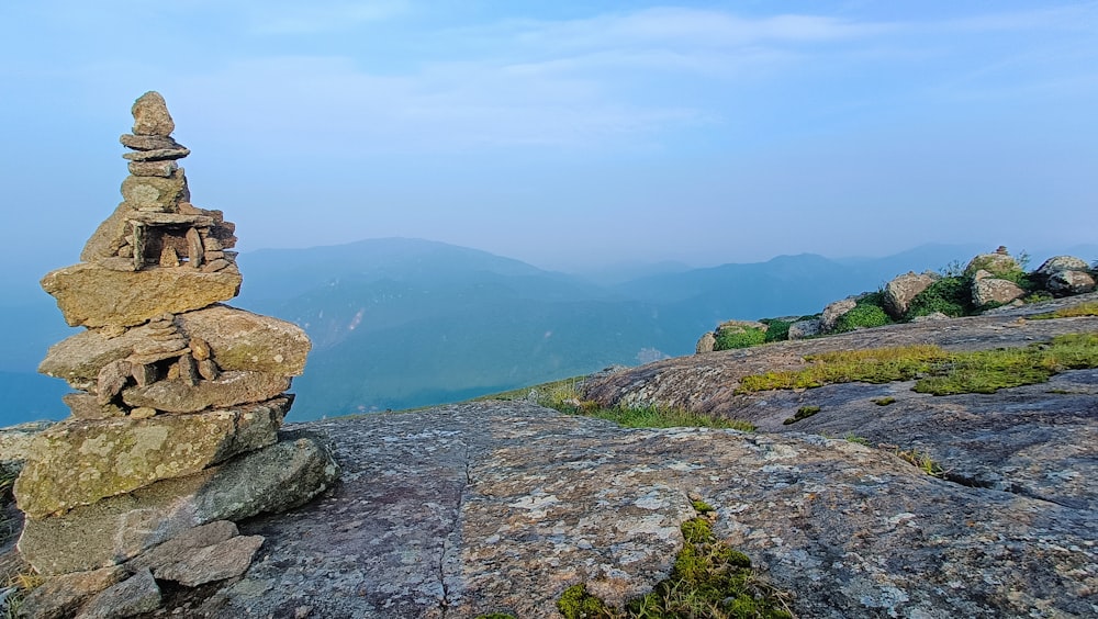 a stack of rocks sitting on top of a mountain