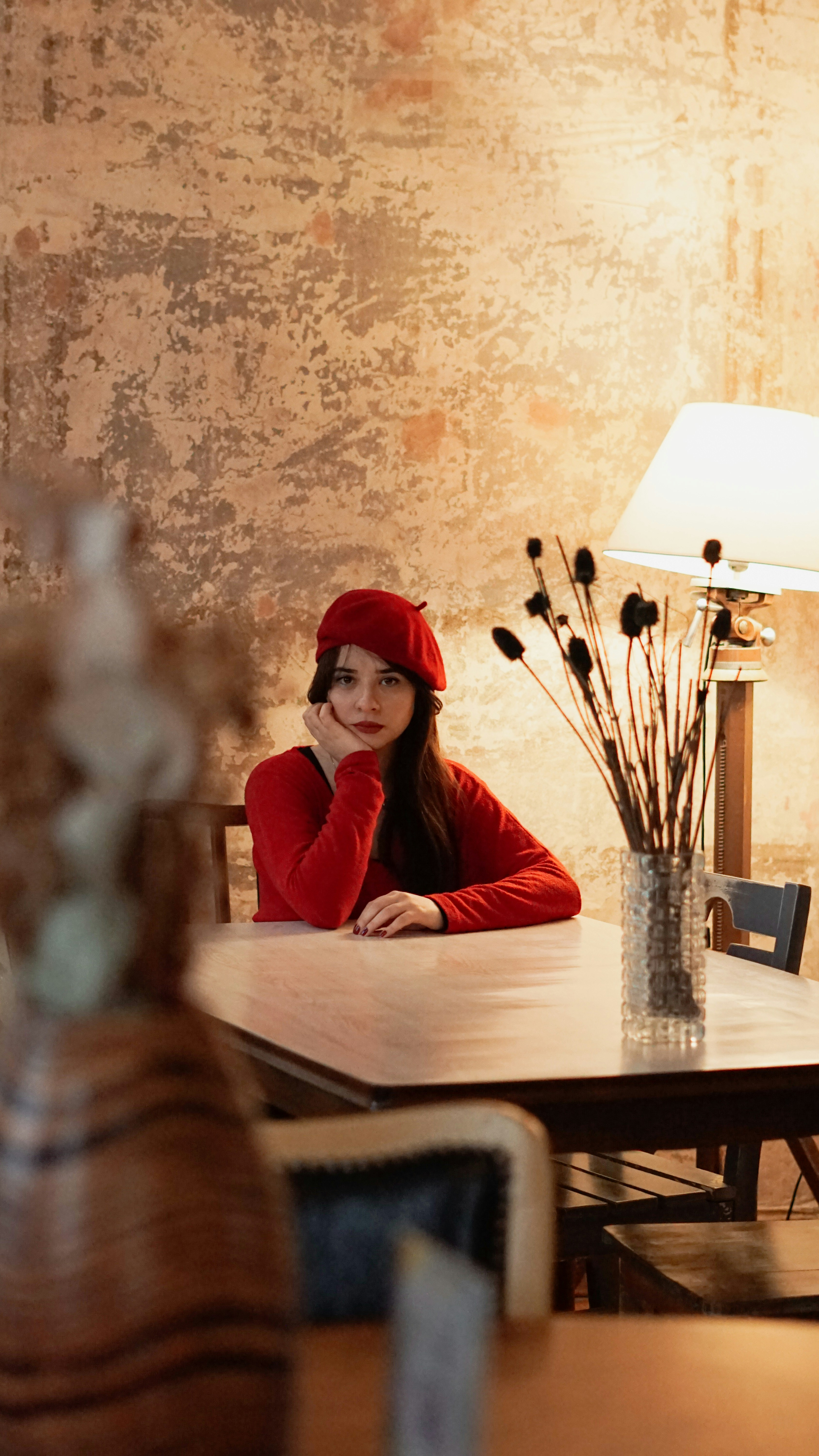 a woman in a red hat sitting at a table