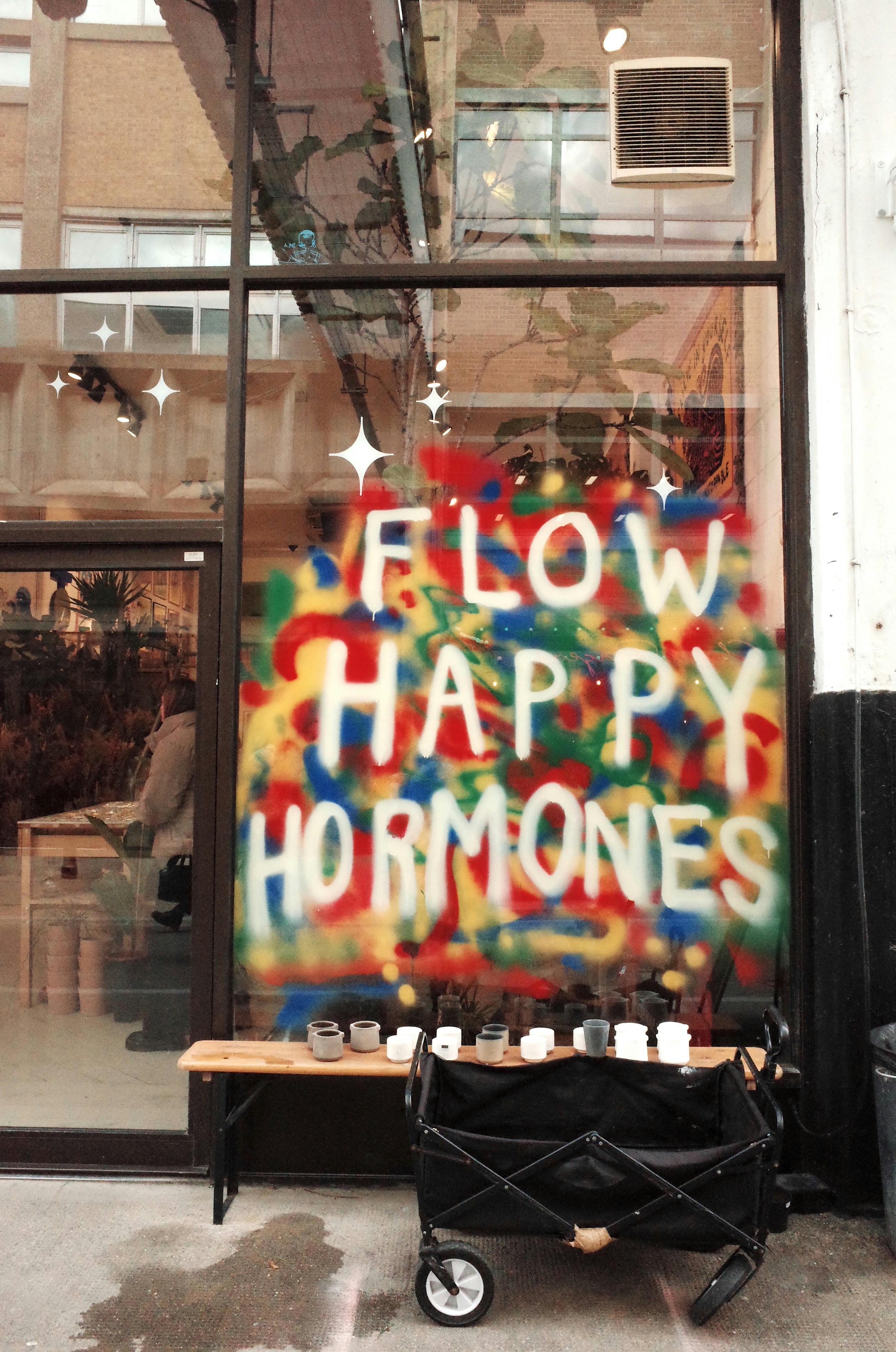a sign that says flow happy hormones on the side of a building