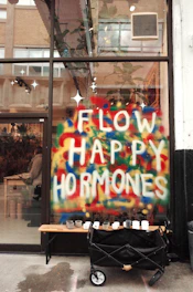 a sign that says flow happy hormones on the side of a building