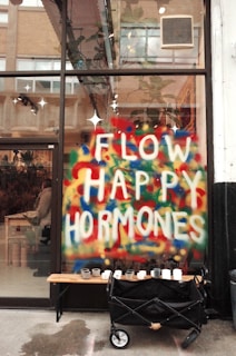 a sign that says flow happy hormones on the side of a building