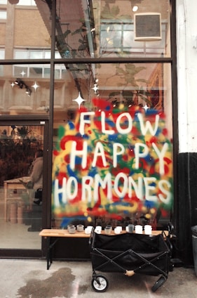 a sign that says flow happy hormones on the side of a building
