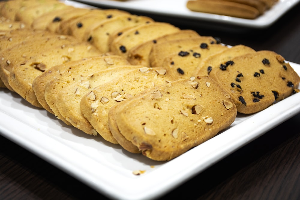 a white plate topped with cookies on top of a wooden table