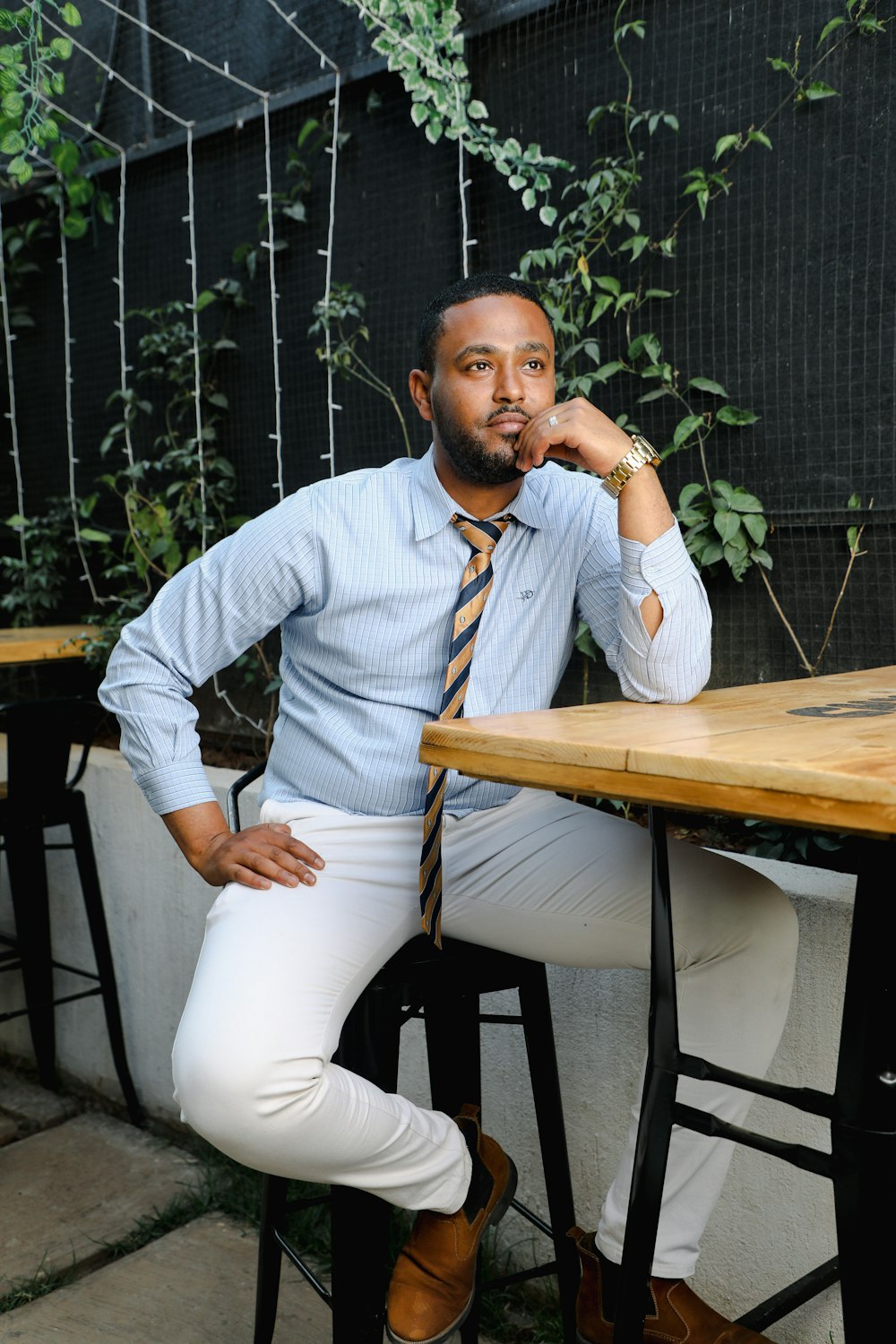 a man sitting at a table wearing a tie