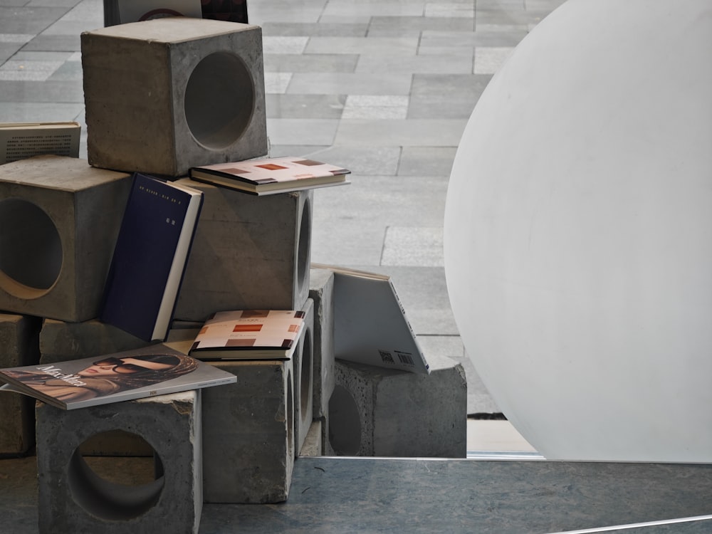 a pile of books sitting on top of cement blocks